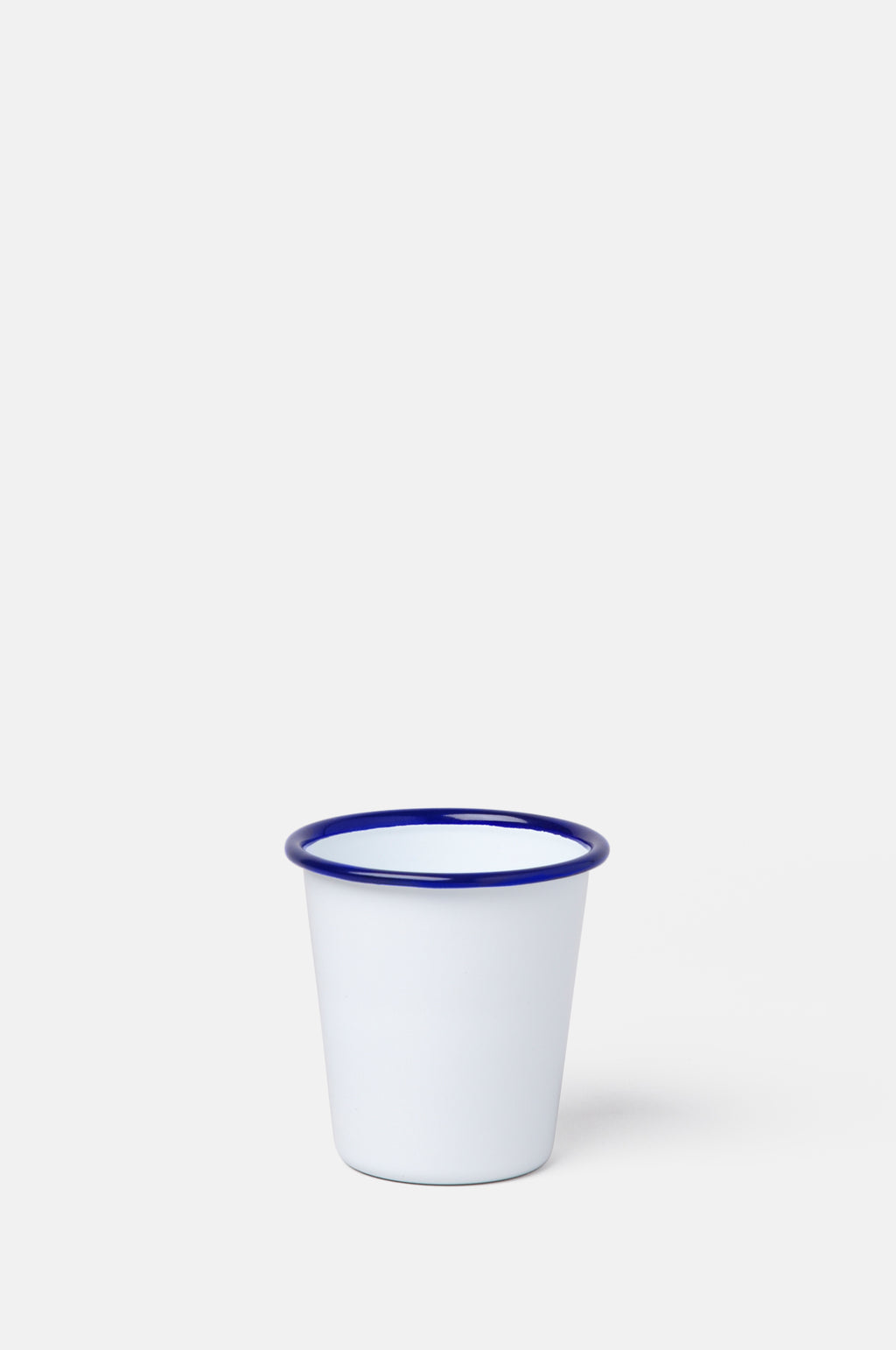 Falcon Enamelware original white tumbler with dark blue rim 9cm tall.